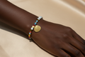 Model wearing Rainbow Crystal Shell Charm Bracelet on wrist